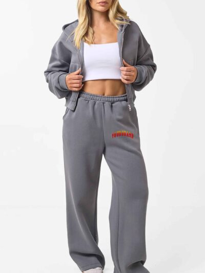 Cropped zip hoodie and sweatpants set. Soft, peach-fuzz fabric. Visible stitching detail. Sporty, feminine loungewear in blus
