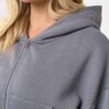 Cropped zip hoodie and sweatpants set. Soft, peach-fuzz fabric. Visible stitching detail. Sporty, feminine loungewear in blus