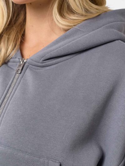 Cropped zip hoodie and sweatpants set. Soft, peach-fuzz fabric. Visible stitching detail. Sporty, feminine loungewear in blus