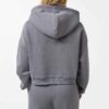 Cropped zip hoodie and sweatpants set. Soft, peach-fuzz fabric. Visible stitching detail. Sporty, feminine loungewear in blus