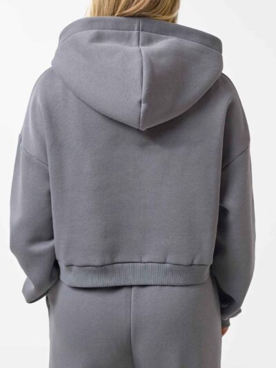Cropped zip hoodie and sweatpants set. Soft, peach-fuzz fabric. Visible stitching detail. Sporty, feminine loungewear in blus