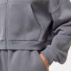 Cropped zip hoodie and sweatpants set. Soft, peach-fuzz fabric. Visible stitching detail. Sporty, feminine loungewear in blus