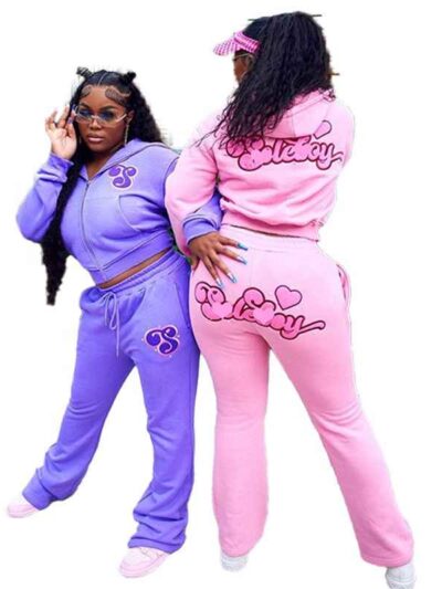 Ladies tracksuit set. Fitted jogger pants & zip-up jacket. Blush pink hue, subtle ribbed texture, clean stitching detail. Fit