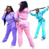 Ladies tracksuit set. Fitted jogger pants & zip-up jacket. Blush pink hue, subtle ribbed texture, clean stitching detail. Fit