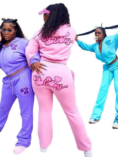 Ladies tracksuit set. Fitted jogger pants & zip-up jacket. Blush pink hue, subtle ribbed texture, clean stitching detail. Fit