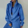 Luxury ladies' tracksuit: soft knit fabric, tailored stitching. Subtle color variation, custom label visible. Comfy, chic sty