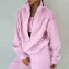Luxury ladies' tracksuit: soft knit fabric, tailored stitching. Subtle color variation, custom label visible. Comfy, chic sty
