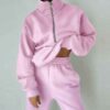 Luxury ladies' tracksuit: soft knit fabric, tailored stitching. Subtle color variation, custom label visible. Comfy, chic sty