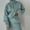 Luxury ladies' tracksuit: soft knit fabric, tailored stitching. Subtle color variation, custom label visible. Comfy, chic sty