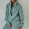 Luxury ladies' tracksuit: soft knit fabric, tailored stitching. Subtle color variation, custom label visible. Comfy, chic sty