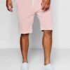 Luxury streetwear shorts, close-up. Black heavy cotton blend, rhinestone logo detail, reinforced stitching. High-end design.