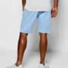 Luxury streetwear shorts, close-up. Black heavy cotton blend, rhinestone logo detail, reinforced stitching. High-end design.