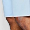 Luxury streetwear shorts, close-up. Black heavy cotton blend, rhinestone logo detail, reinforced stitching. High-end design.