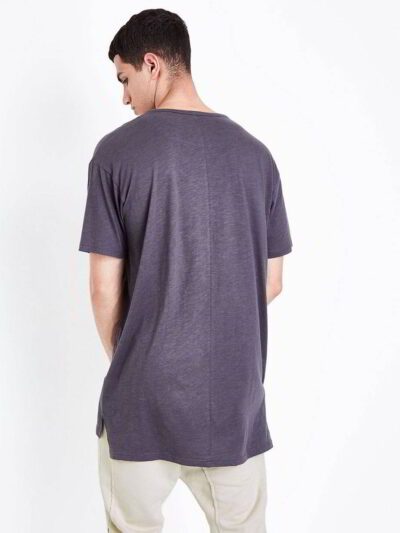 Close-up of a vibrant polyester performance t-shirt. Note the fine, breathable knit, smooth texture, and reinforced stitching