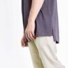 Close-up of a vibrant polyester performance t-shirt. Note the fine, breathable knit, smooth texture, and reinforced stitching