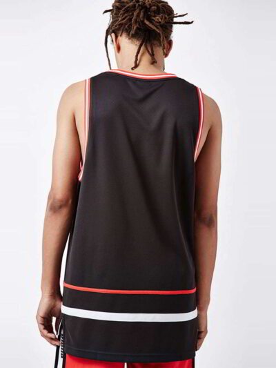 Close-up of a soft, cotton tank top. Fine stitching highlights the armhole. Breathable, lightweight fabric in a heathered gre