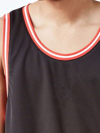 Close-up of a soft, cotton tank top. Fine stitching highlights the armhole. Breathable, lightweight fabric in a heathered gre