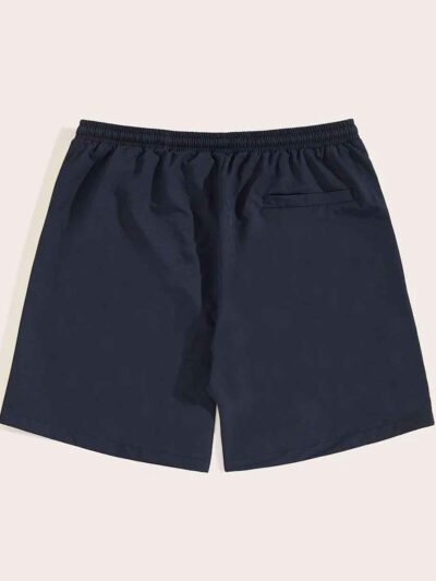 Navy swim trunks, quick-dry fabric with subtle sheen. Note reinforced stitching & clean silhouette. Ideal resort apparel. - V