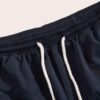 Navy swim trunks, quick-dry fabric with subtle sheen. Note reinforced stitching & clean silhouette. Ideal resort apparel. - V