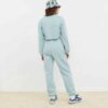 Women's running tracksuit set. Close-up on soft, slightly textured fabric. Zip-up jacket with pink trim. Comfortable fit for