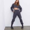 Women's running tracksuit set. Close-up on soft, slightly textured fabric. Zip-up jacket with pink trim. Comfortable fit for