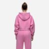 Women's tracksuit set in muted tones. Visible fine stitching, soft-looking knit fabric. Corporate uniform or team wear. - Vie