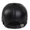 Close-up of a brown golf hat in textured PU leather with earflaps. Adjustable strap visible; fine stitching detail. - View 5