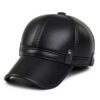 Close-up of a brown golf hat in textured PU leather with earflaps. Adjustable strap visible; fine stitching detail. - View 6