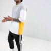 Oversized t-shirt with color block panels and embroidered text. Close up shows soft texture, quality stitching, and relaxed f