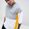 Oversized t-shirt with color block panels and embroidered text. Close up shows soft texture, quality stitching, and relaxed f