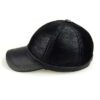 Baseball cap with earflaps, faux leather texture, visible stitching detail. Dark brown color, cozy design for cold weather. -