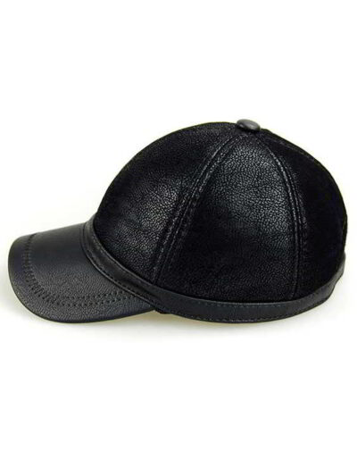 Baseball cap with earflaps, faux leather texture, visible stitching detail. Dark brown color, cozy design for cold weather. -