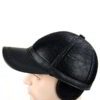 Baseball cap with earflaps, faux leather texture, visible stitching detail. Dark brown color, cozy design for cold weather. -