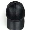 Baseball cap with earflaps, faux leather texture, visible stitching detail. Dark brown color, cozy design for cold weather. -