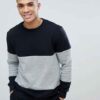 Black and grey crew neck sweatshirt, ribbed knit texture, patch detail. Relaxed fit, visible stitching, ideal for layering. -