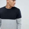 Black and grey crew neck sweatshirt, ribbed knit texture, patch detail. Relaxed fit, visible stitching, ideal for layering. -