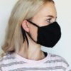 Reusable face mask, soft fabric, visible stitching detail. Breathable medical-style mask, adjustable ear loops for snug fit.