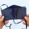 Reusable face mask, soft fabric, visible stitching detail. Breathable medical-style mask, adjustable ear loops for snug fit.