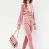Cropped pink velour tracksuit. Heavyweight fabric, visible plush texture. Luxurious winter set with detailed stitching and a