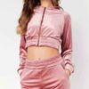 Cropped pink velour tracksuit. Heavyweight fabric, visible plush texture. Luxurious winter set with detailed stitching and a