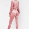 Cropped pink velour tracksuit. Heavyweight fabric, visible plush texture. Luxurious winter set with detailed stitching and a