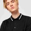 Close-up of a blank polo shirt. Smooth pique knit, clean stitching. Ready for printing, embroidery. Available in various colo