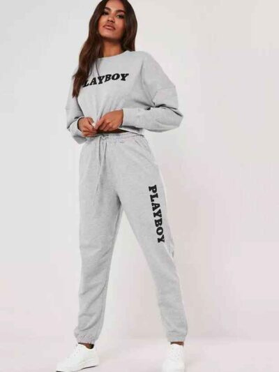 Gray lounge joggers, soft knit, close-up on textured fabric. Relaxed fit, cuffed ankles. Quality stitching visible on seams.