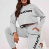 Gray lounge joggers, soft knit, close-up on textured fabric. Relaxed fit, cuffed ankles. Quality stitching visible on seams.