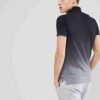 Close-up of a polo shirt, embroidered logo detail. Soft, fine knit fabric texture. High-quality stitching visible. Premium fe
