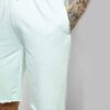 Relaxed fit cotton drawstring shorts. Soft, visible weave and fine stitching. Hints of natural dyes suggest subtle color vari