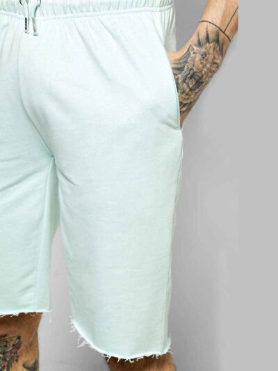 Relaxed fit cotton drawstring shorts. Soft, visible weave and fine stitching. Hints of natural dyes suggest subtle color vari