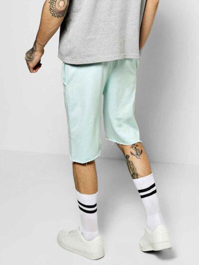 Relaxed fit cotton drawstring shorts. Soft, visible weave and fine stitching. Hints of natural dyes suggest subtle color vari
