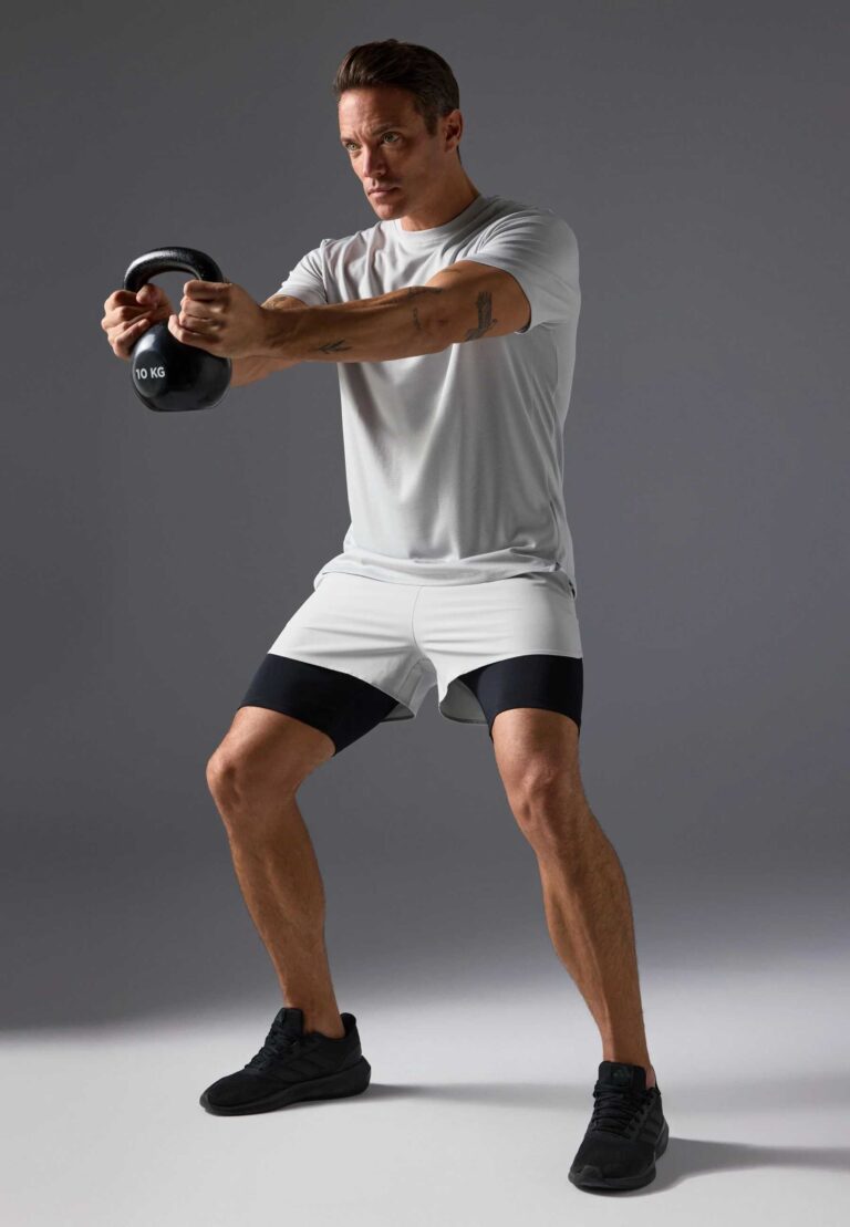 Men's two-piece short set. Textured, lightweight fabric, likely cotton blend. Matching top and shorts. Sharp, visible stitchi