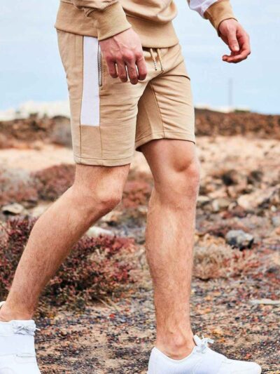 Close-up of custom workout shorts. Breathable fabric, reinforced stitching, subtle logo placement. Performance activewear, da